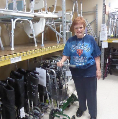 Woman handing out walkers at the lending closet